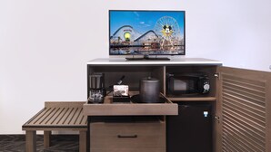 A compact kitchenette with a microwave, coffee maker, and a small refrigerator. - Tropicana Inn and Suites (Anaheim)