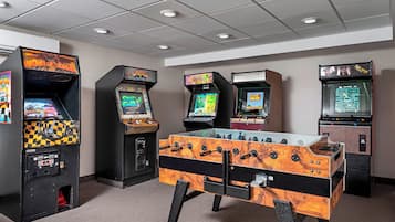 Enjoy gaming with arcade games and a foosball table in this entertainment room.