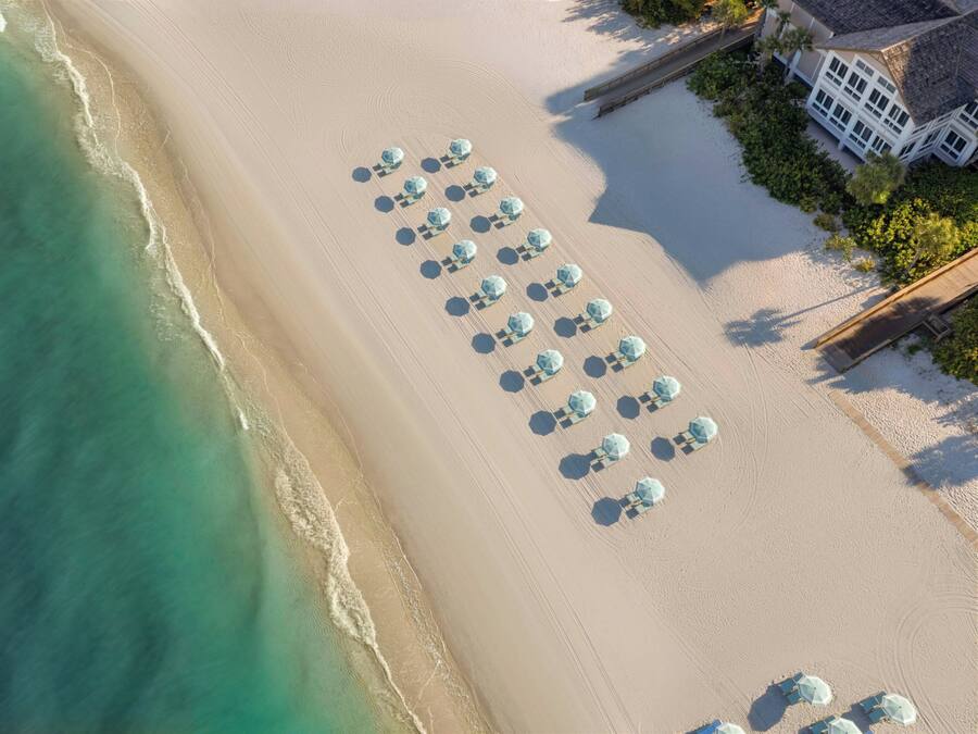 On the beach, white sand, beach cabanas, sun loungers