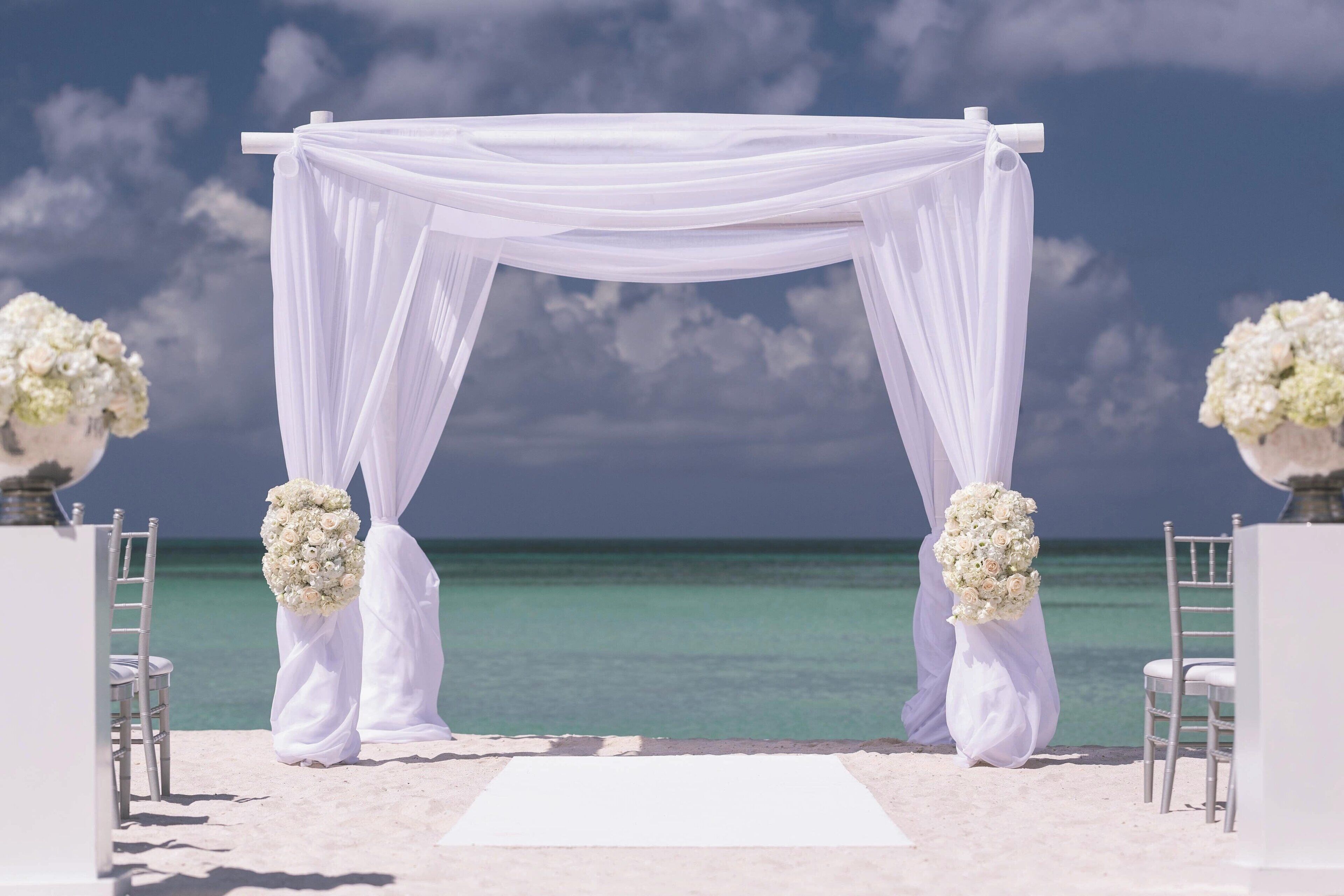 on the beach, white sand, beach cabanas, sun-loungers