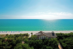 On the beach, white sand, beach cabanas, sun-loungers