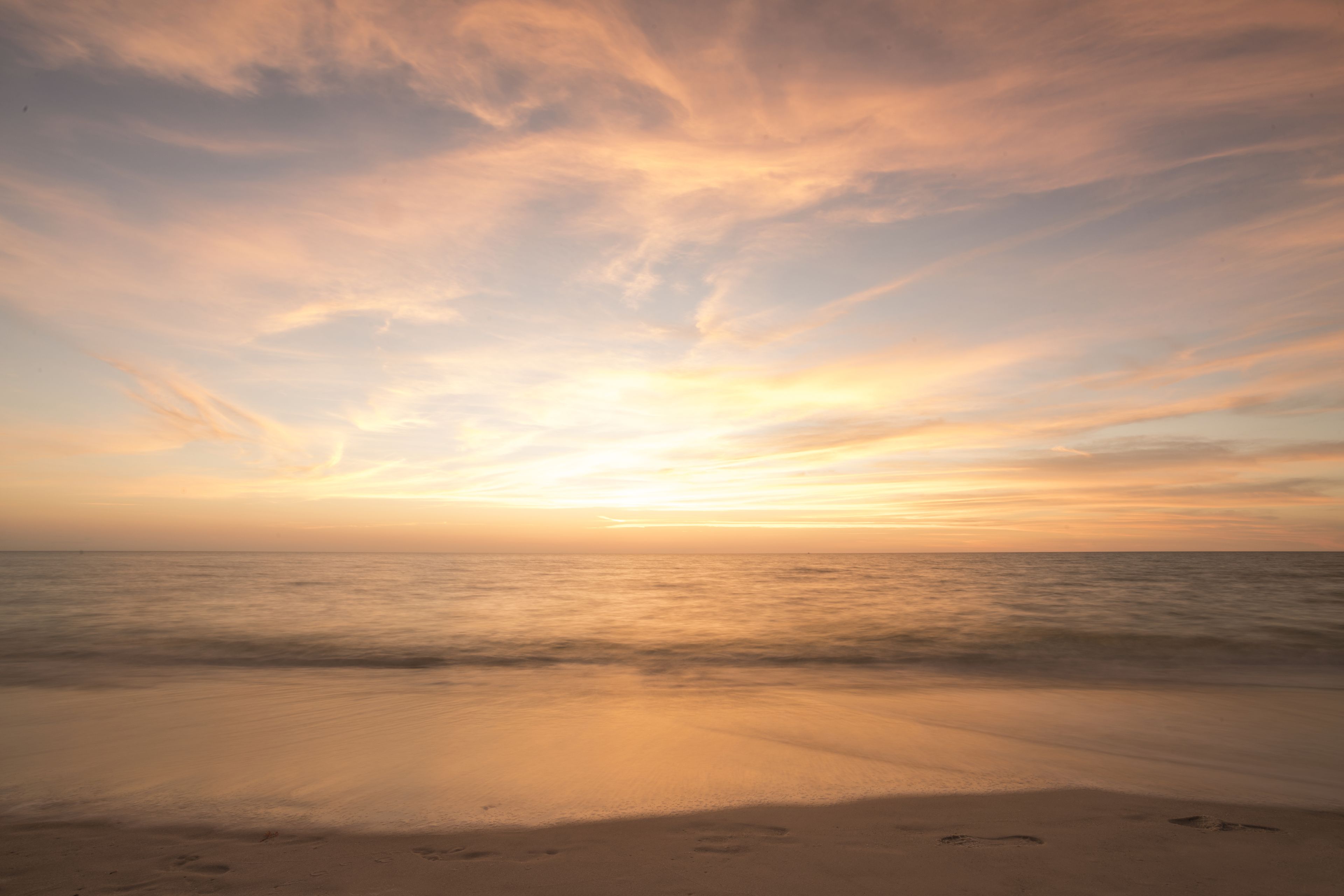 On the beach, white sand, beach cabanas, sun loungers