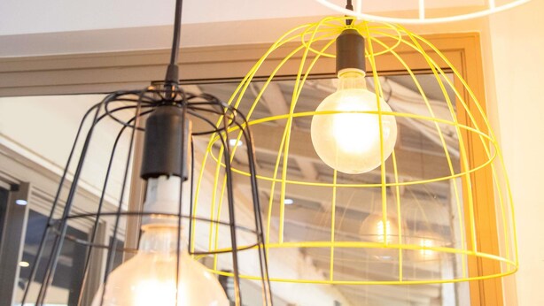 A modern interior with hanging pendant lights and a large window. - ibis Styles Karratha (Karratha)