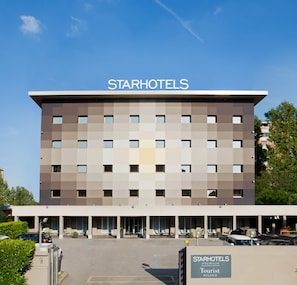 A StarHotels building with a modern design, multiple windows, and a clear sky. - Starhotels Tourist (Milan)