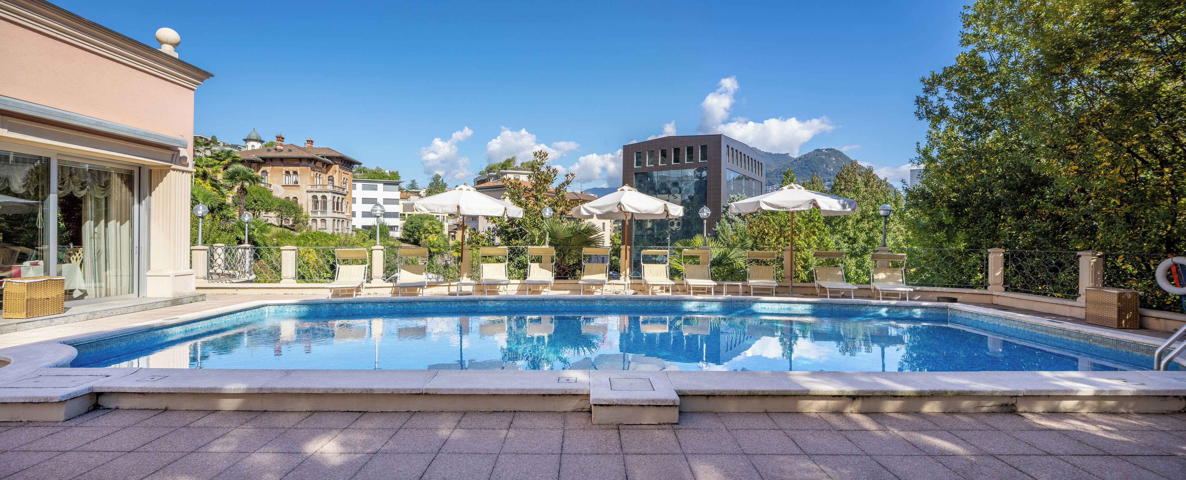 Seasonal outdoor pool, open 9:00 AM to 8:00 PM, pool umbrellas