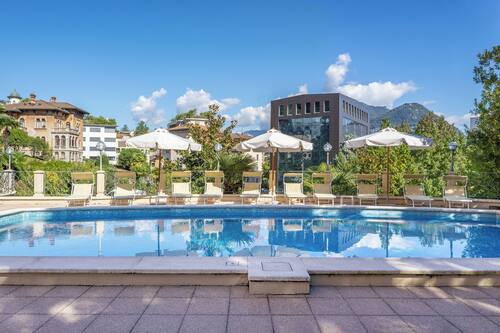 Seasonal outdoor pool, open 9:00 AM to 8:00 PM, pool umbrellas