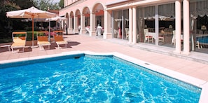 Seasonal outdoor pool, open 9:00 AM to 8:00 PM, pool umbrellas