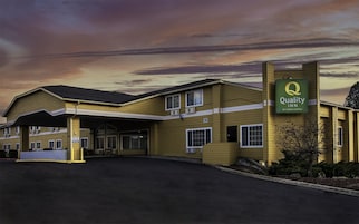 A Quality Inn by Choice Hotels with a covered parking area and a prominent sign.