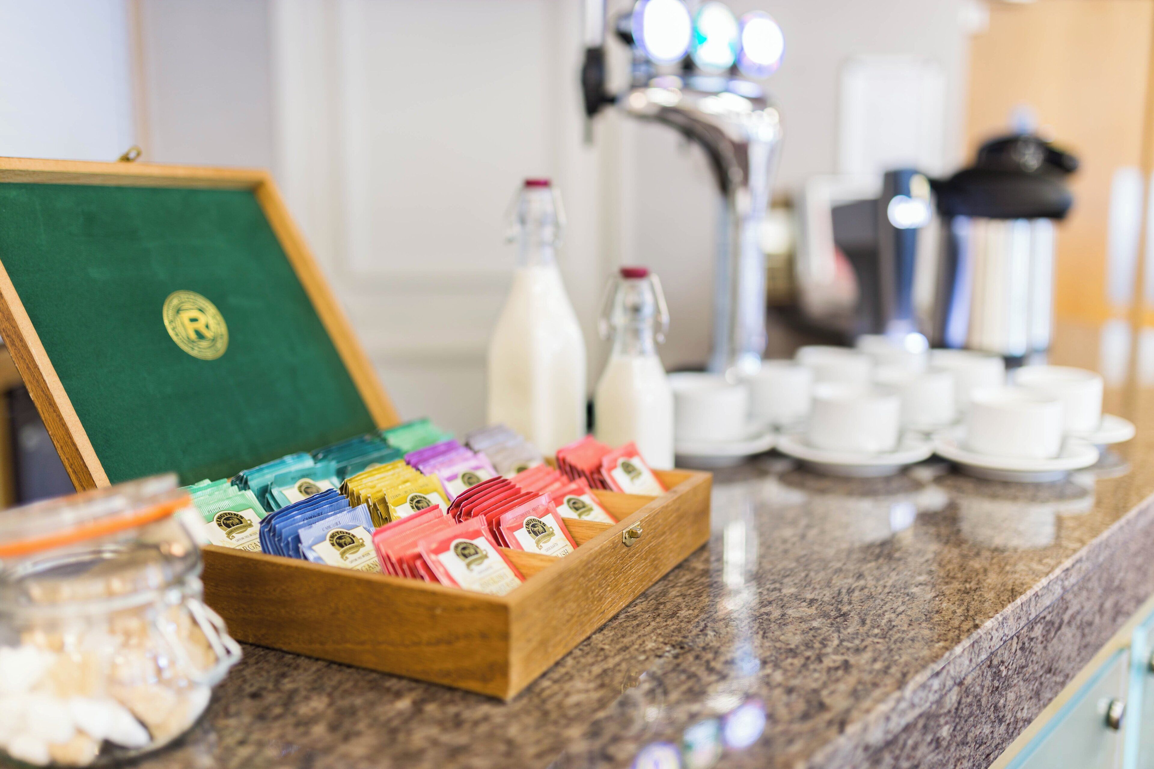 A breakfast buffet setup with various food items and condiments.