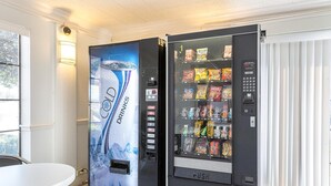 A vending machine with a water dispenser on the left and a snack vending machine on the right. - Motel 6 Dallas, TX - Market Center (Dallas)