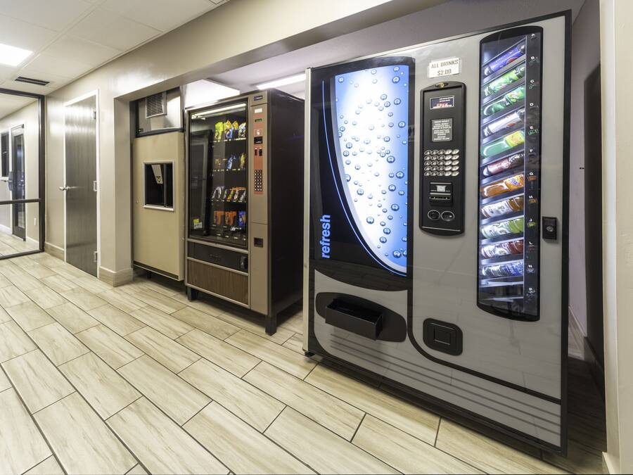 A corridor with vending machines and a self-service kiosk.