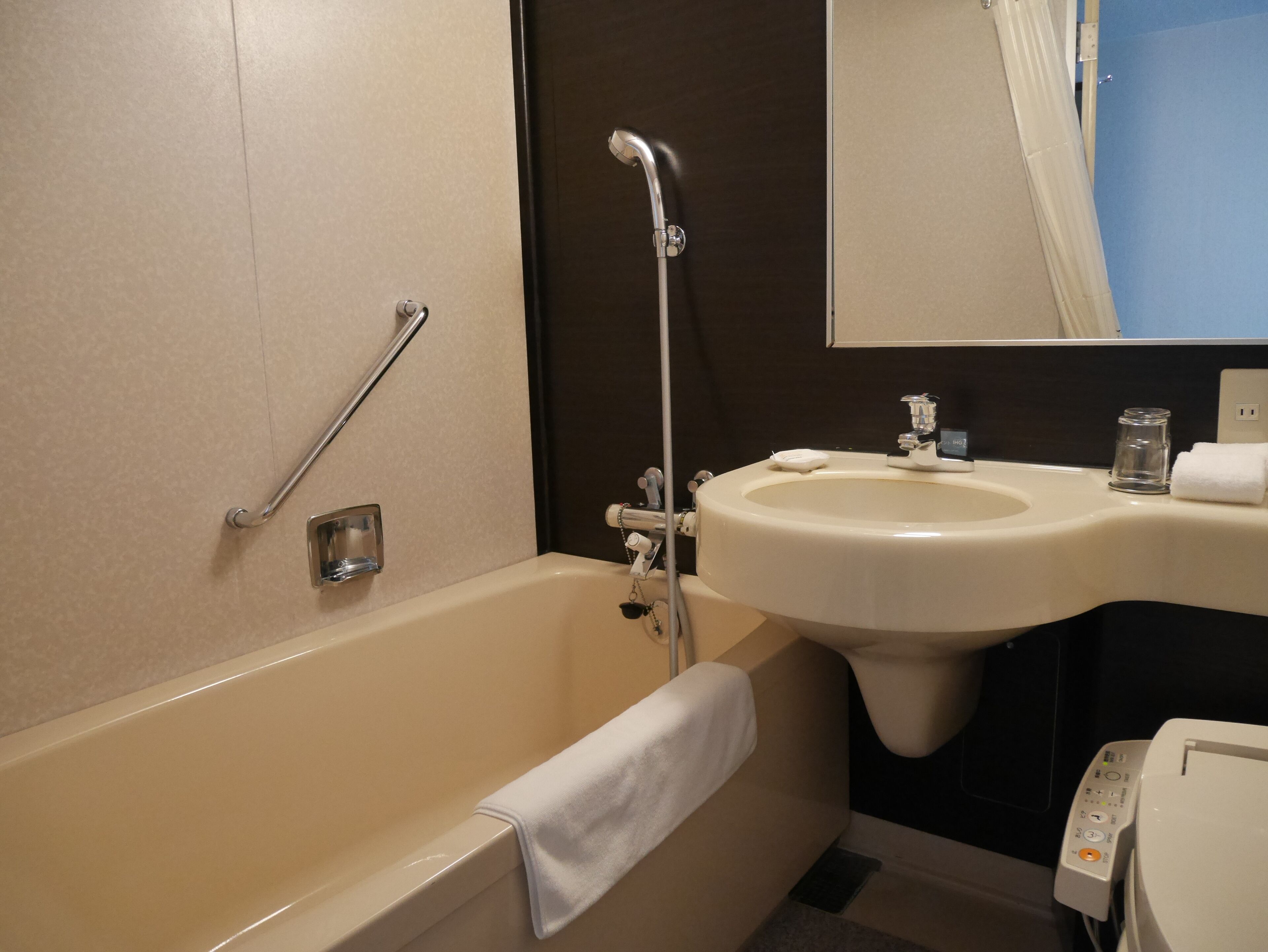 A bathroom with a bathtub, a sink, and a toilet.
