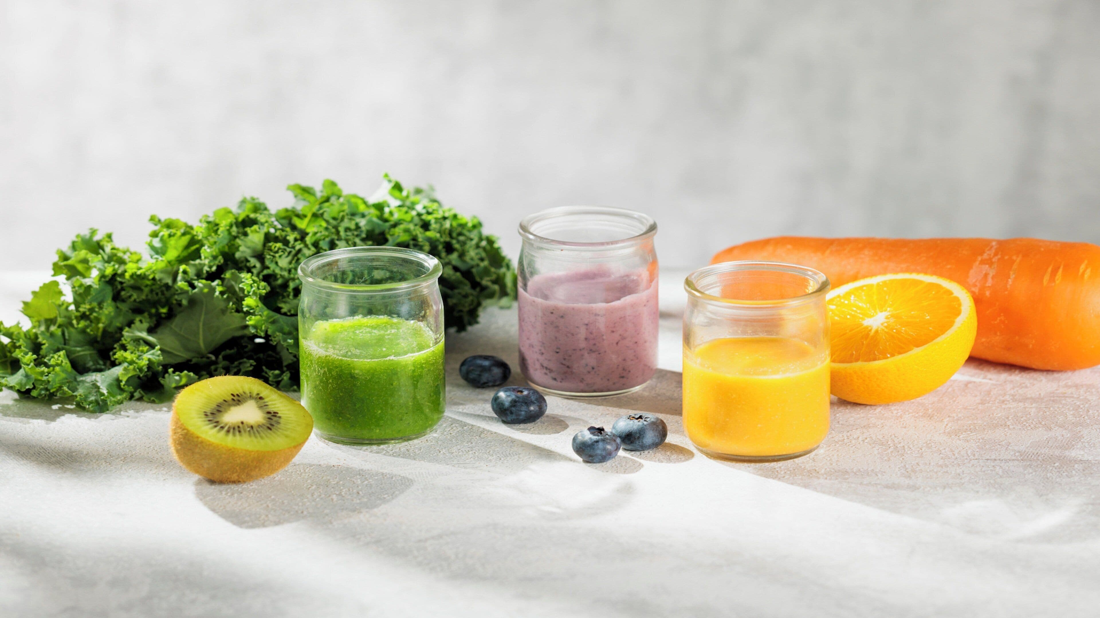 A table with various fruits and smoothies.