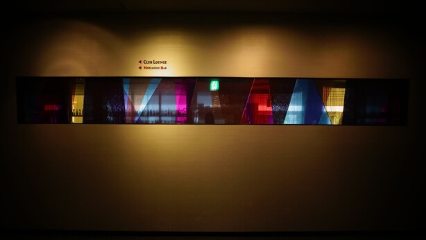 A hallway with a sign indicating the Club Lounge and Mezzanine Bar.