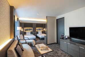 A modern hotel room with a sofa, two single beds, a TV, and a minibar. - ANA Crowne Plaza Fukuoka by IHG (Fukuoka)