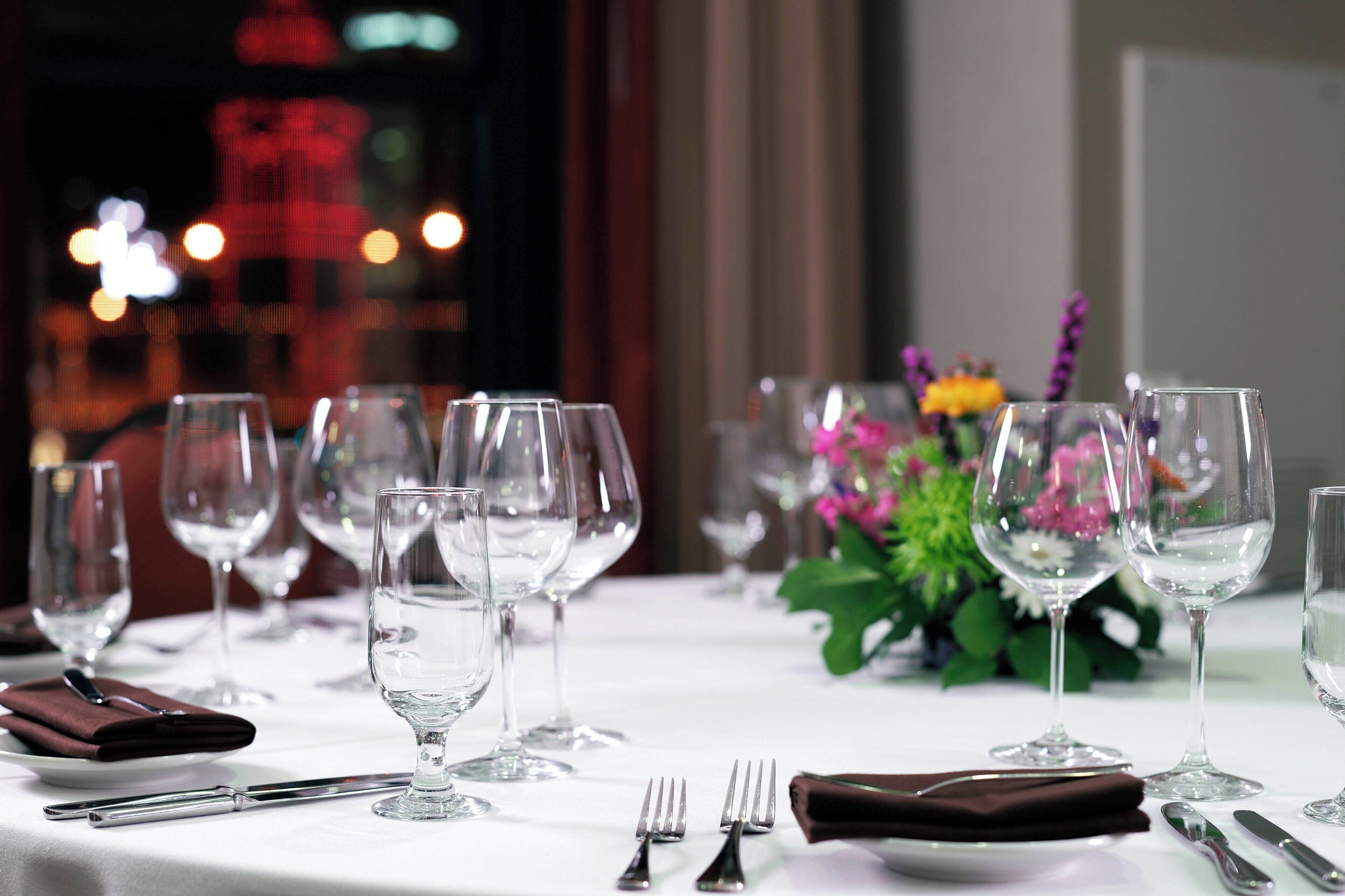 A table set for dining with wine glasses, forks, and a napkin.