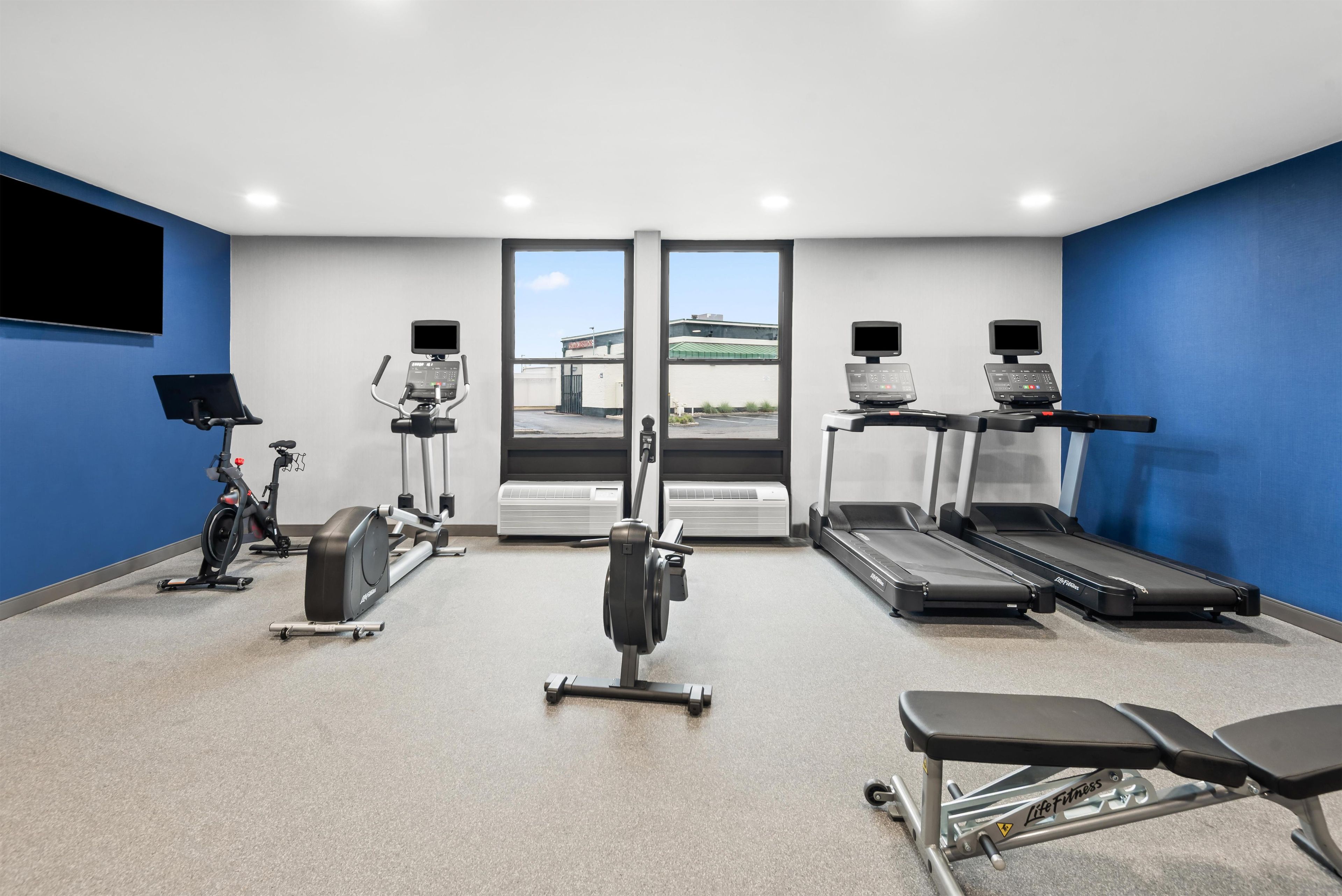 A fitness center with treadmills, an elliptical, and a stationary bike.