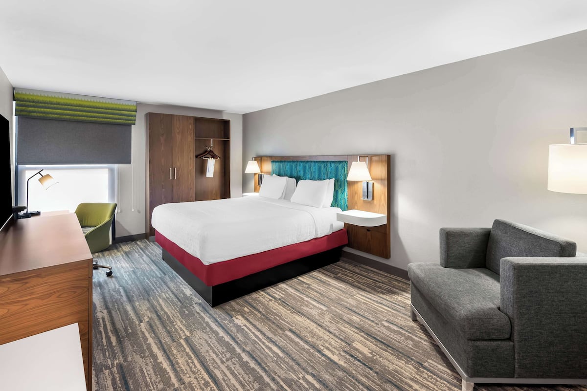 Hypo-allergenic bedding, desk, laptop workspace, blackout drapes