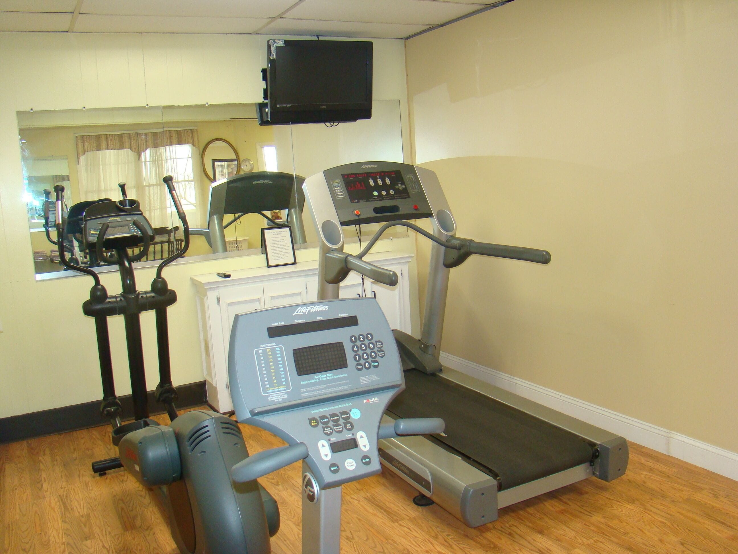 A gym with treadmills, stationary bikes, and weight machines.