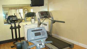 A gym with treadmills, stationary bikes, and weight machines.
