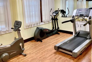 A home gym with a treadmill, elliptical, and stationary bike. - Baymont by Wyndham Front Royal Near Shenandoah National Park (Front Royal)