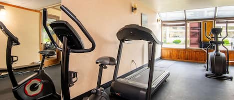 A gym with treadmills, an elliptical, and a stationary bike.