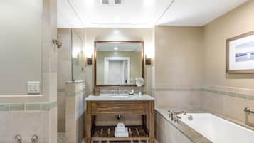 Une salle de bain moderne avec un meuble-lavabo en bois, un grand miroir, une baignoire et une douche.
