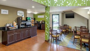 A breakfast area with a counter, seating, and a TV screen.