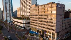 A modern hotel with multiple floors, a rooftop garden, and a prominent entrance with a sign. - Gooderson Tropicana Hotel (Durban)