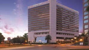 A DoubleTree by Hilton hotel with a modern design, featuring a large glass facade and a prominent sign at the top. - DoubleTree by Hilton Hotel Orlando Downtown (Orlando)