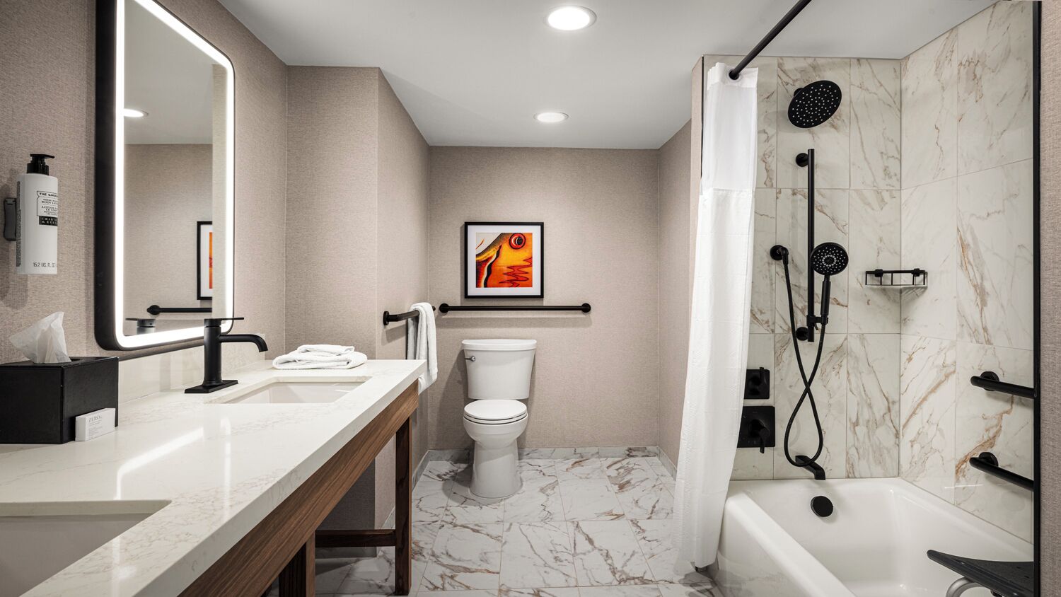 A modern bathroom with a vanity, toilet, and shower.