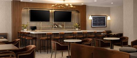 A bar area with multiple stools, a counter, and a television screen.