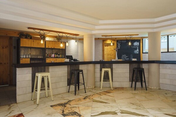A bar area with a counter, stools, and a chalkboard menu. - Crisol Jardines de Córdoba (Córdoba)