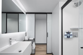 Combined shower/tub, designer toiletries, hair dryer, towels at YOTEL Washington DC