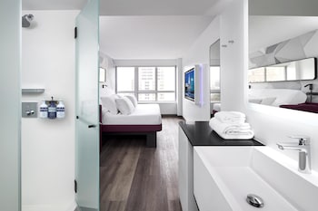 Premium Plus King | Premium bedding, in-room safe, desk, laptop workspace at YOTEL Washington DC