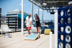 A deck with outdoor seating and a shuffleboard table.
