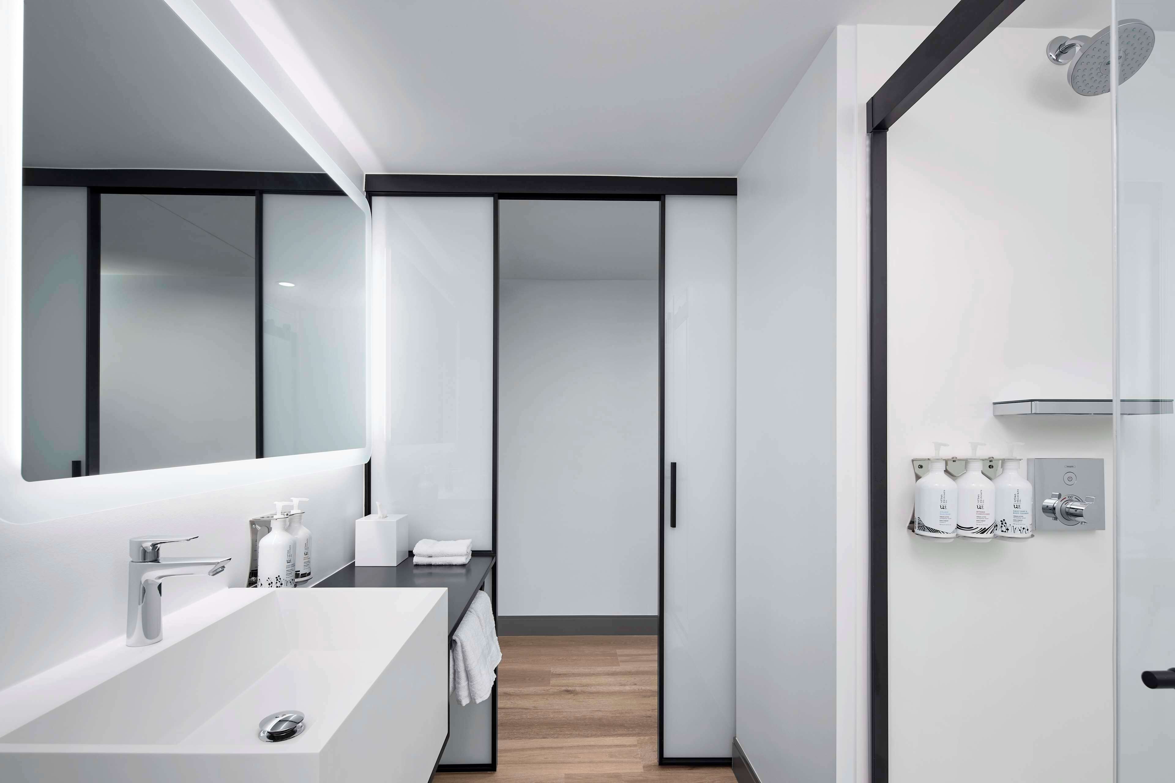 combined shower/bathtub, designer toiletries, hair dryer, towels