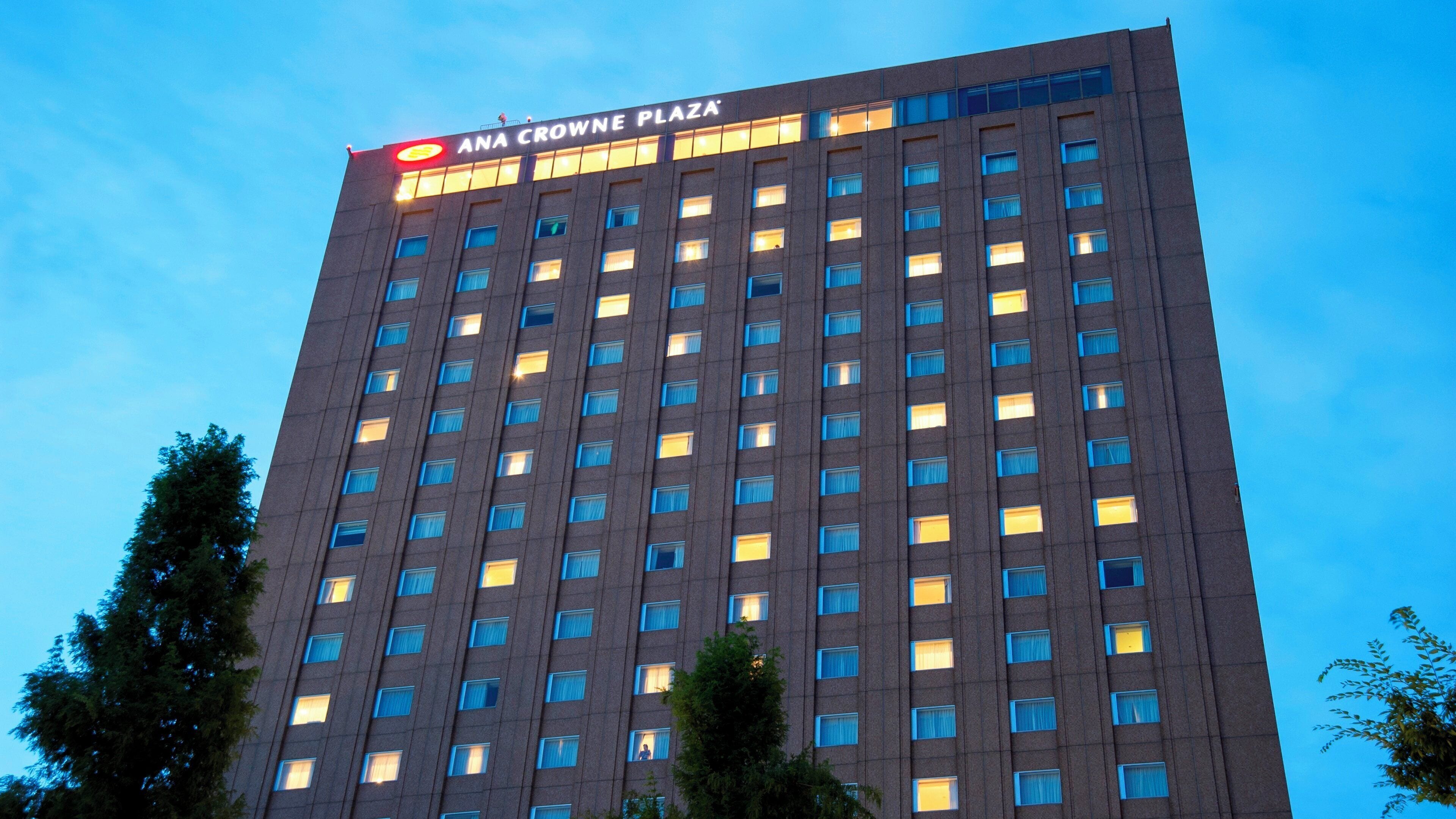 A high-rise building with a sign reading 'ANA CROWNE PLAZA'.