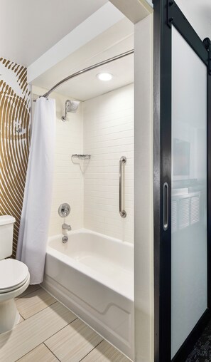 A modern bathroom with a white bathtub, a shower, and a toilet. - Renaissance Asheville Downtown Hotel (Asheville)
