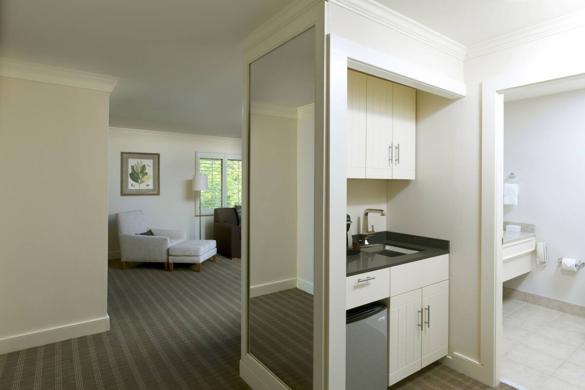 A modern bathroom with a sink, toilet, and shower area.