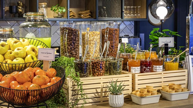 A buffet with various food items, including fruits, nuts, and condiments. - ibis Nanterre la Défense (Nanterre)