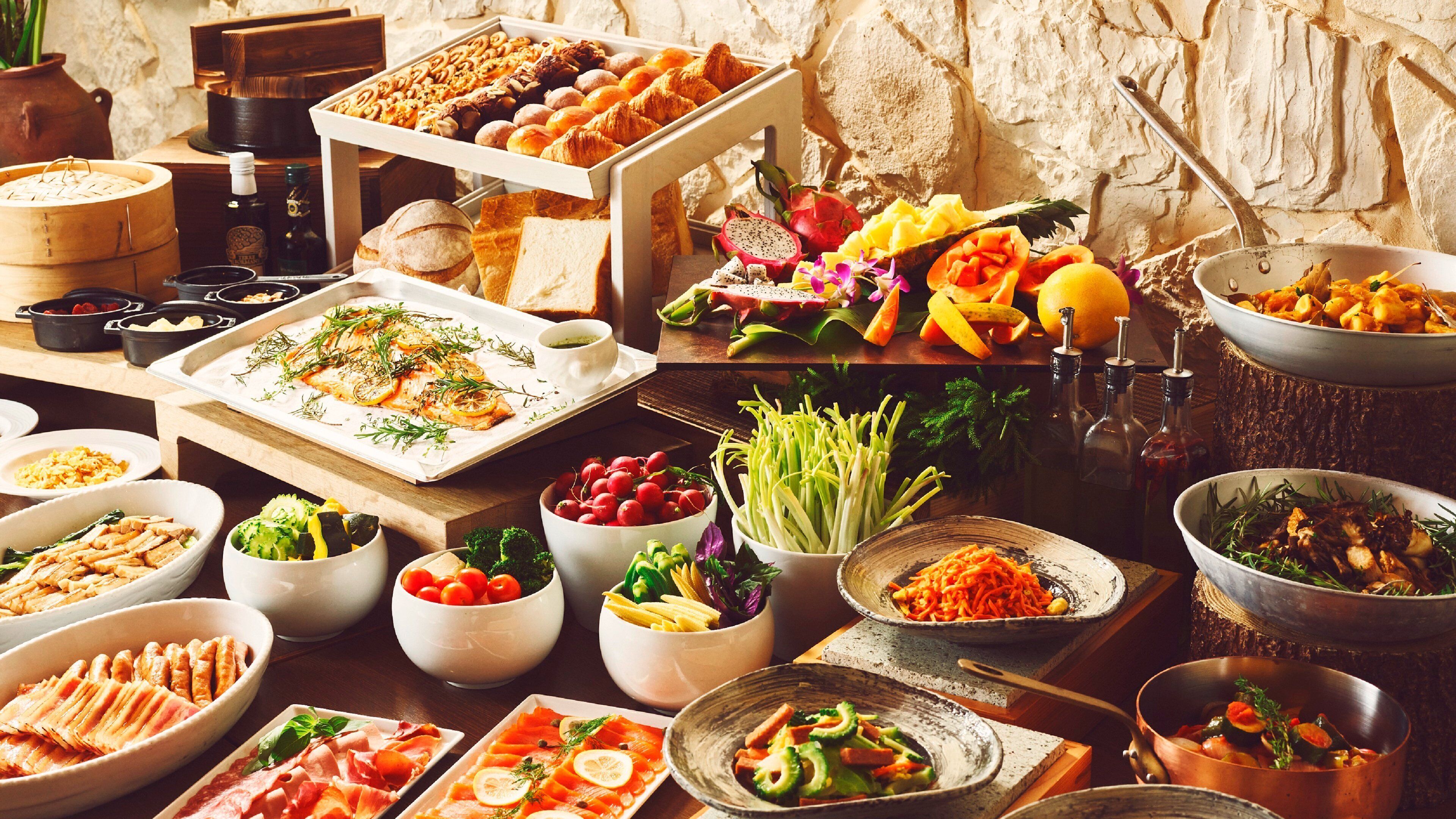 A buffet with various dishes including seafood, salads, and pastries.