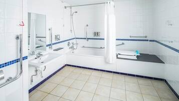 A modern bathroom with a walk-in shower, a sink, and a bathtub.