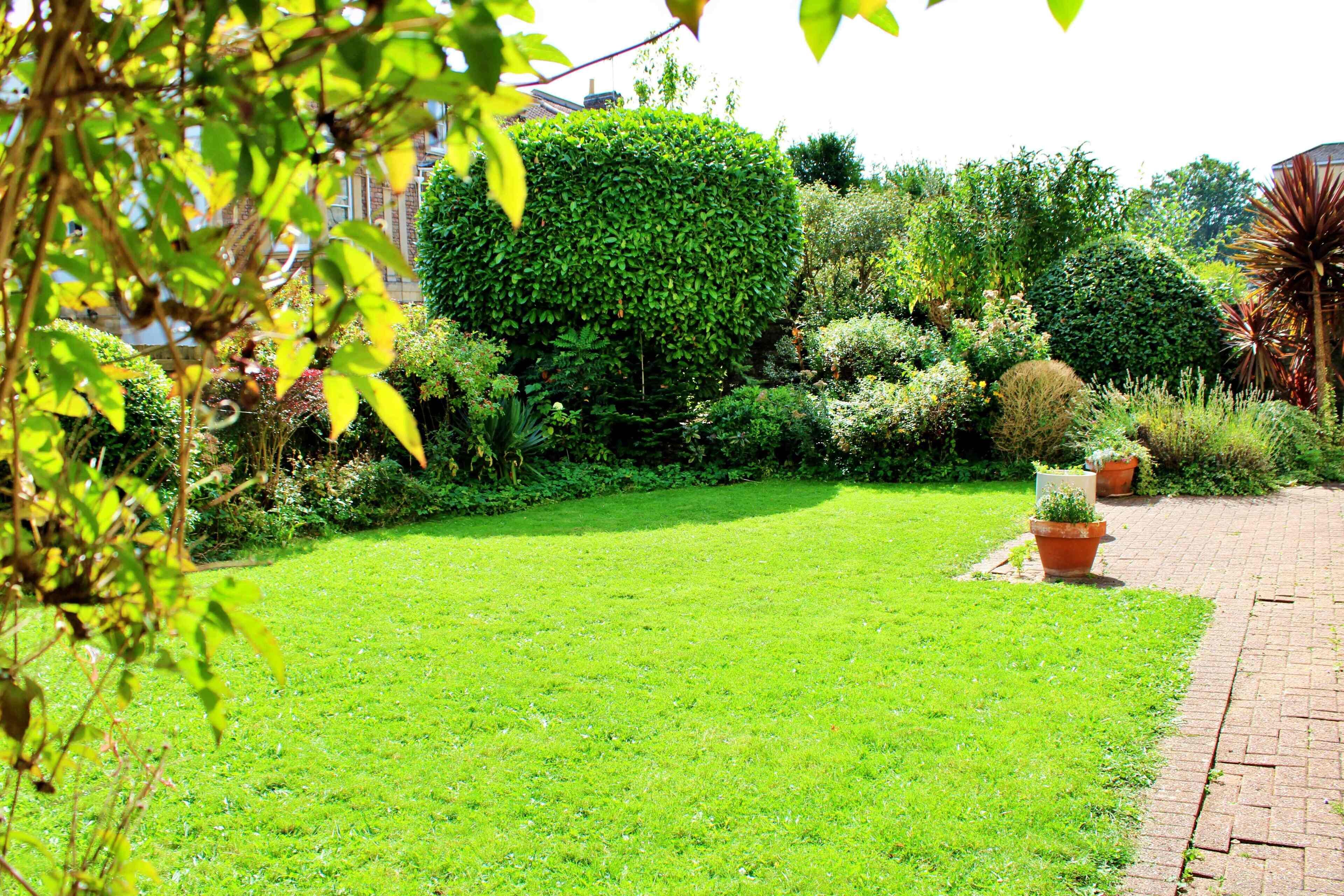 A well-maintained garden with a variety of plants and a neatly trimmed lawn.