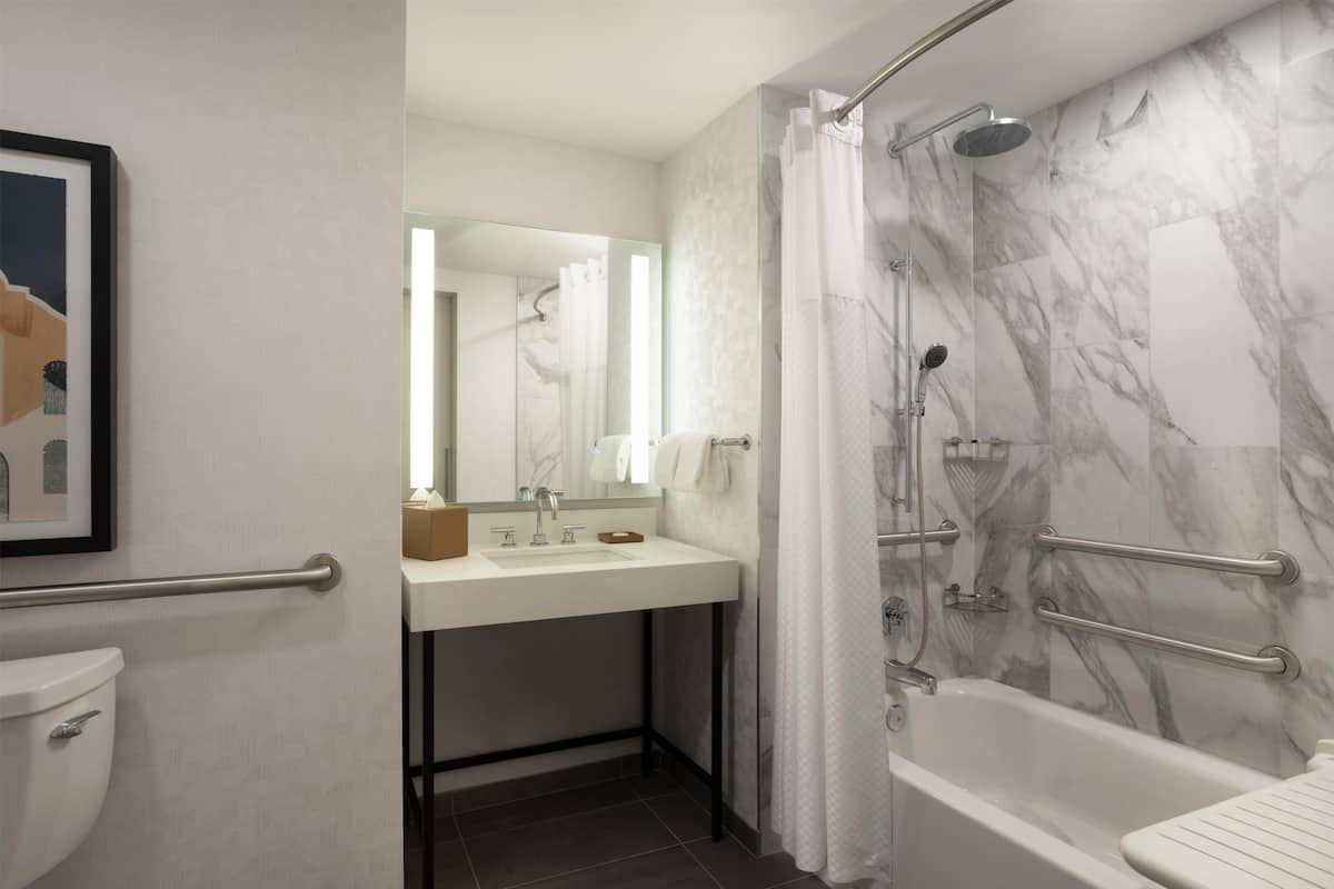 Combined shower/tub, designer toiletries, hair dryer, towels