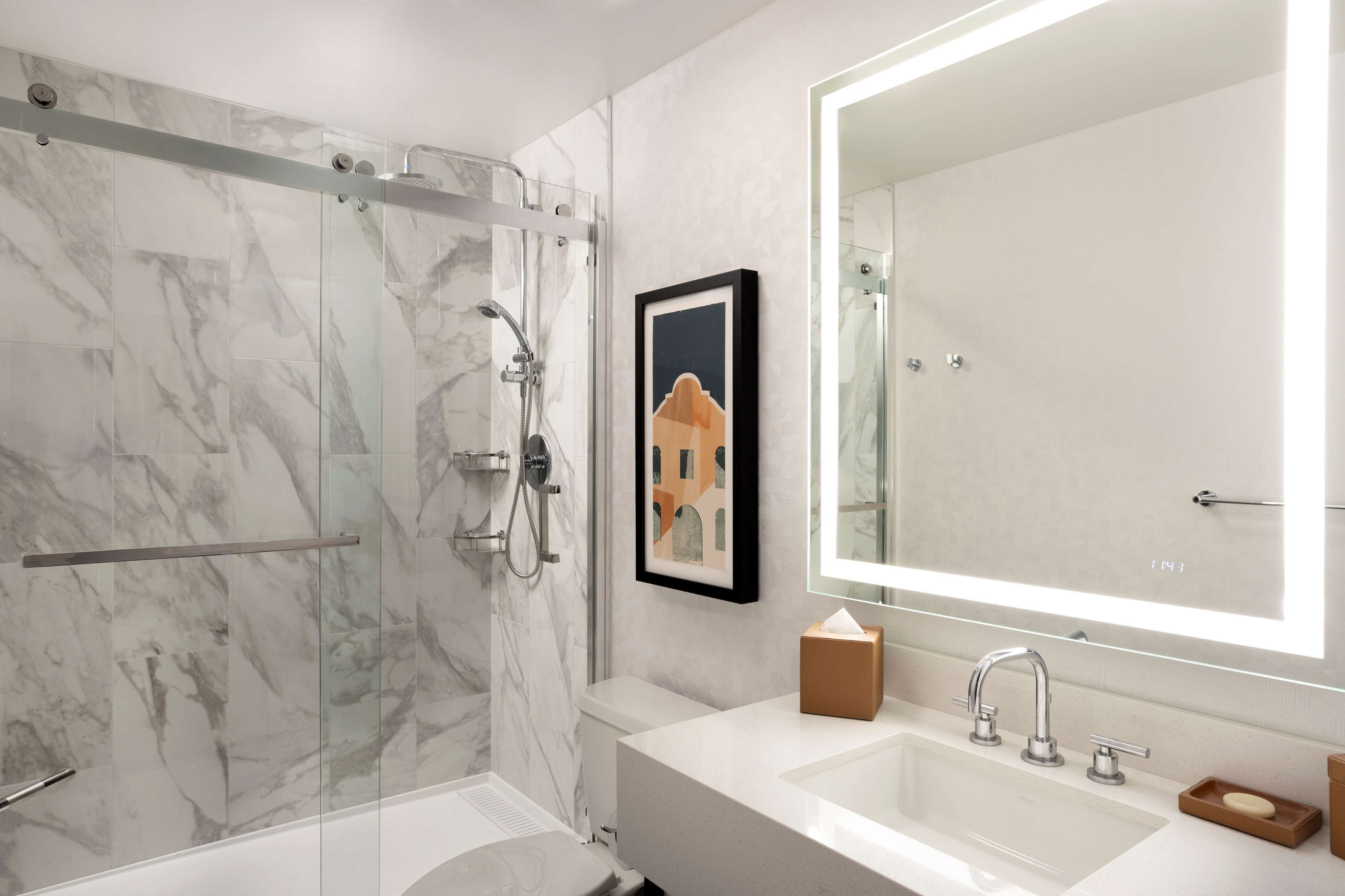 combined shower/bathtub, designer toiletries, hair dryer, towels