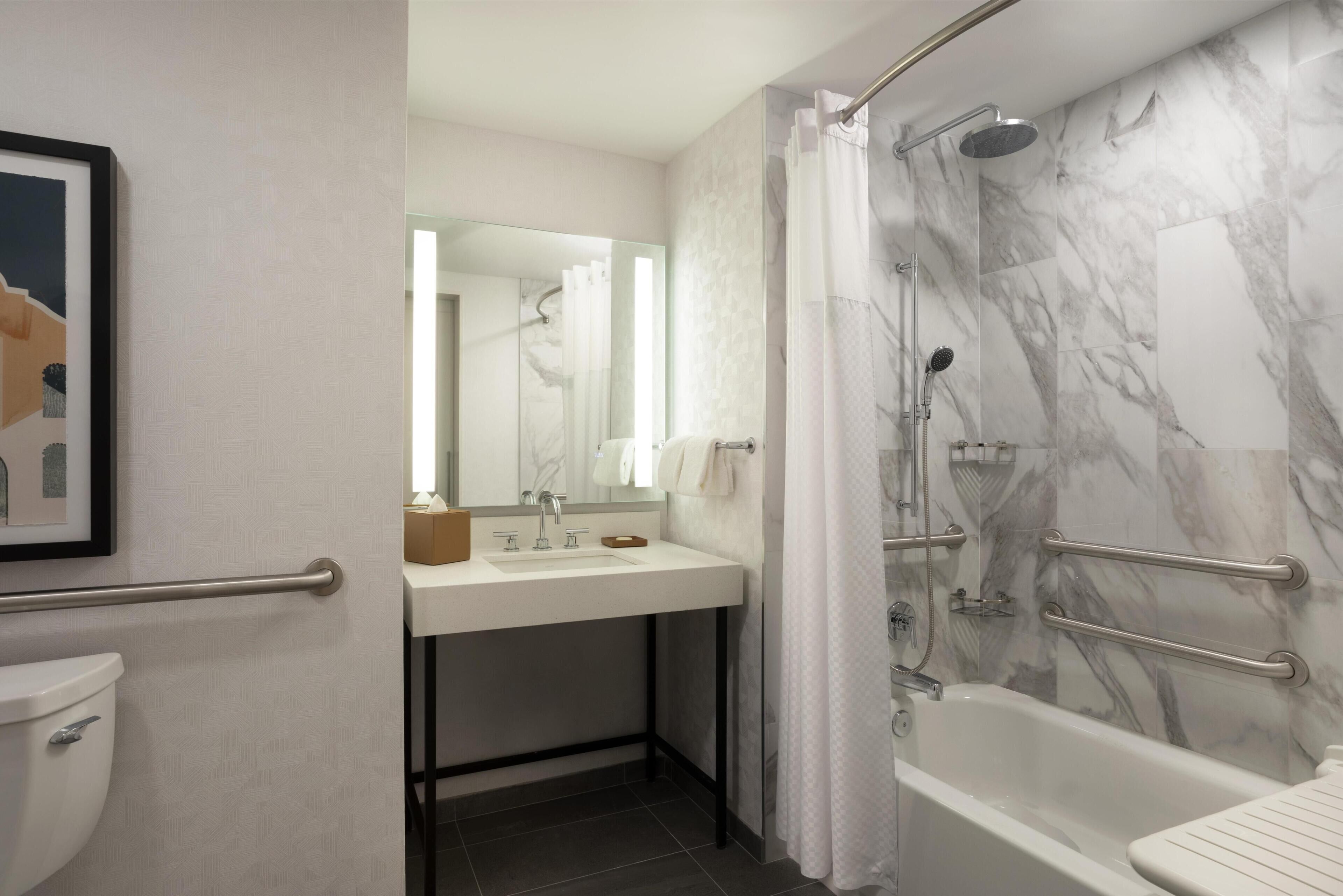 Combined shower/bathtub, designer toiletries, hair dryer, towels
