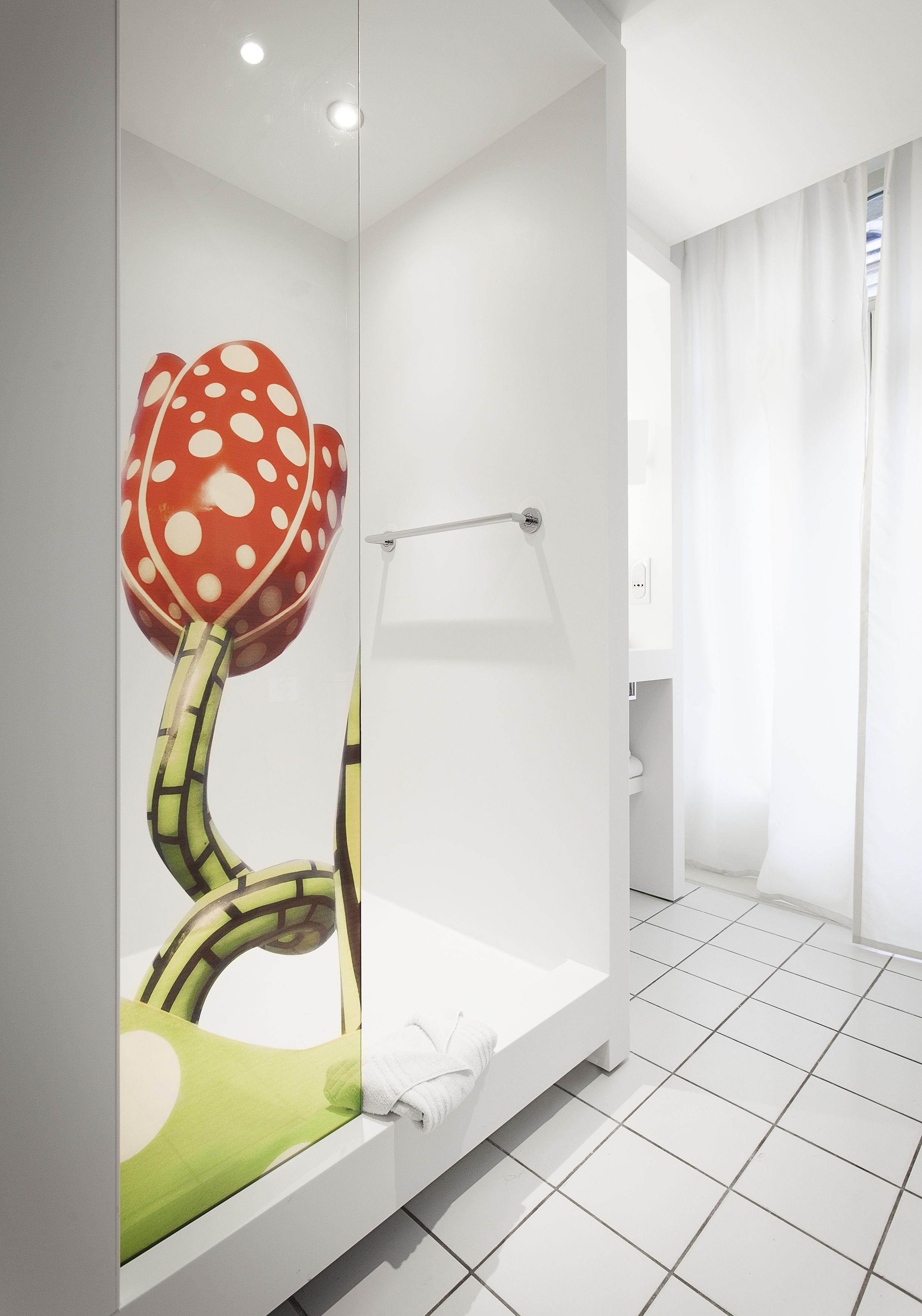 A modern bathroom with a shower, a toilet, and a sink.