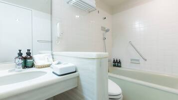 A bathroom with a white sink, a toilet, and a bathtub.