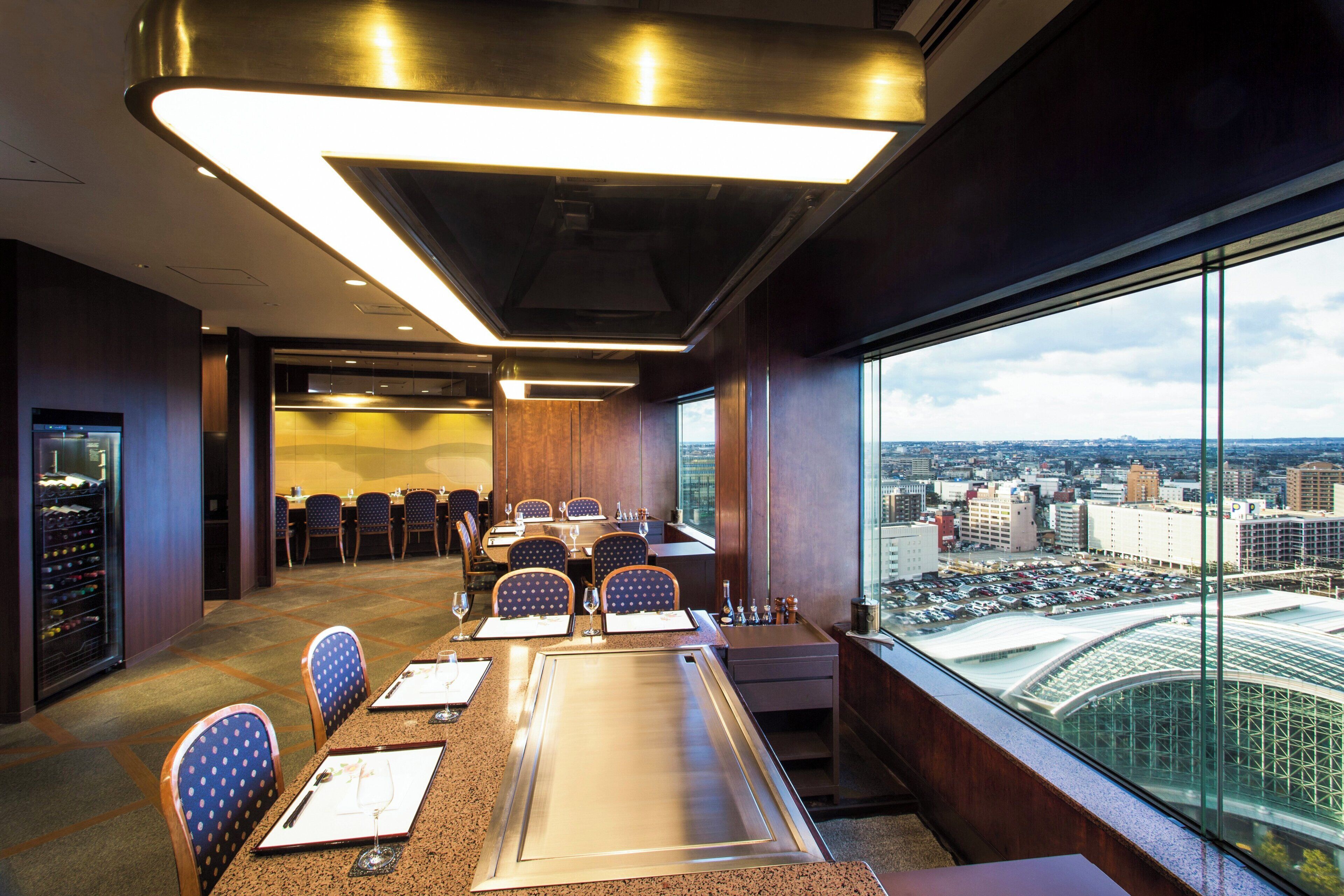 A conference room with a city view, a large table, and several chairs.